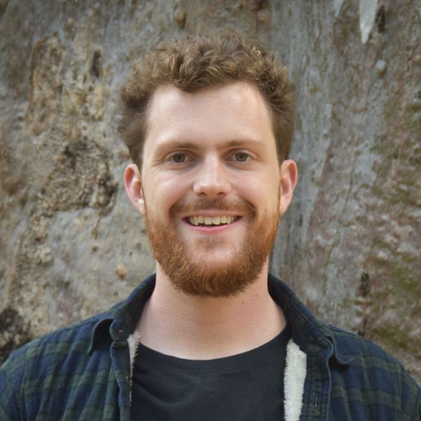 Portrait photo of Ben Weightman standing by a old tree